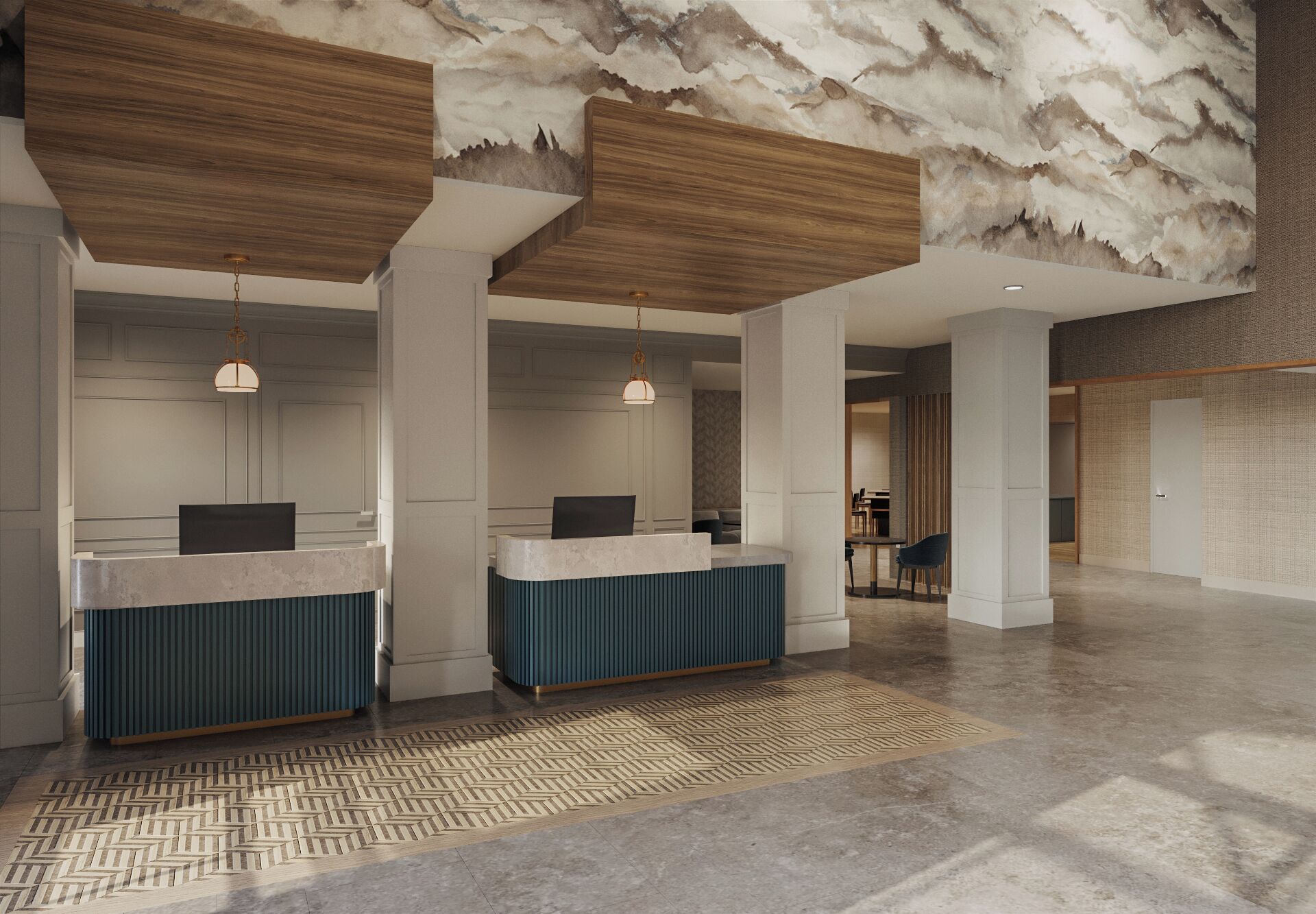 A spacious lobby with a reception desk, seating area, and a patterned floor.