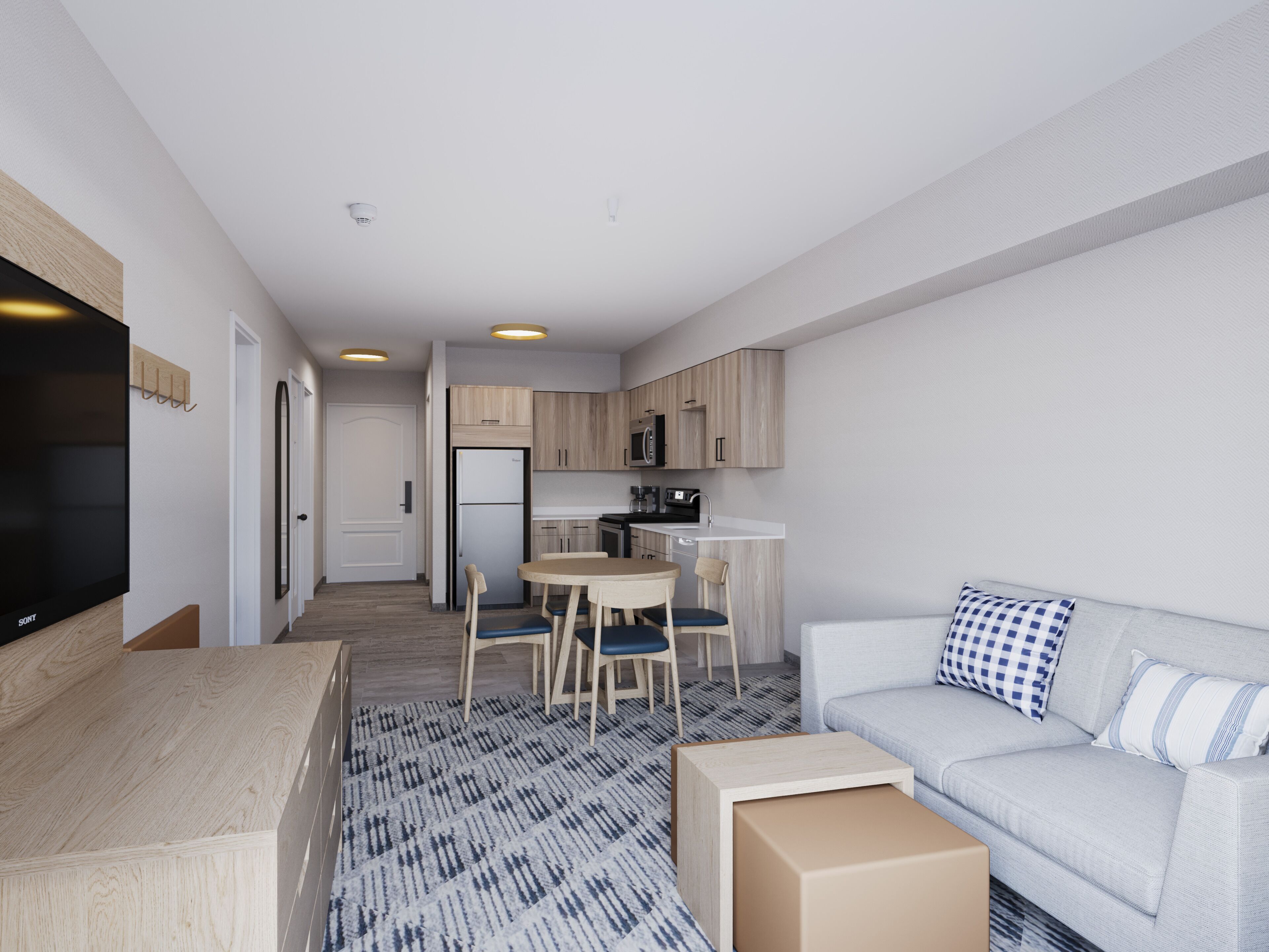 Ein modernes Apartment mit Wohnzimmer, Essbereich und Küche.