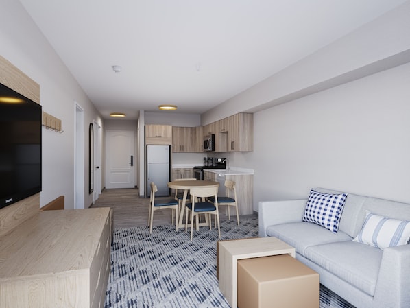 A modern apartment with a living room, dining area, and kitchen. - Pomeroy Inn & Suites Hotel Dawson Creek (Dawson Creek)