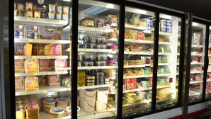 Refrigerated display cases in a grocery store with various dairy products and packaged goods. - West Plaza Hotel Desekel (Koror)
