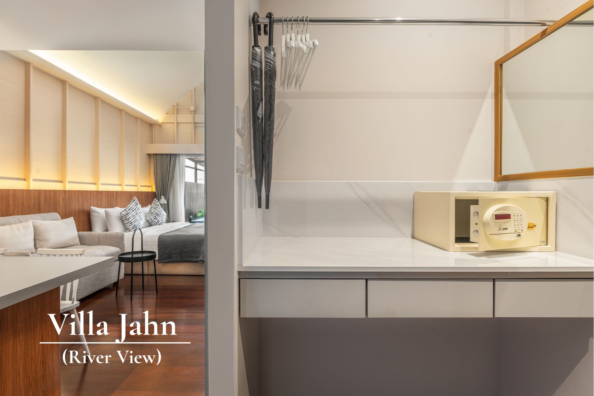 A modern hotel room with a sofa, a dining table, and a view of the river.