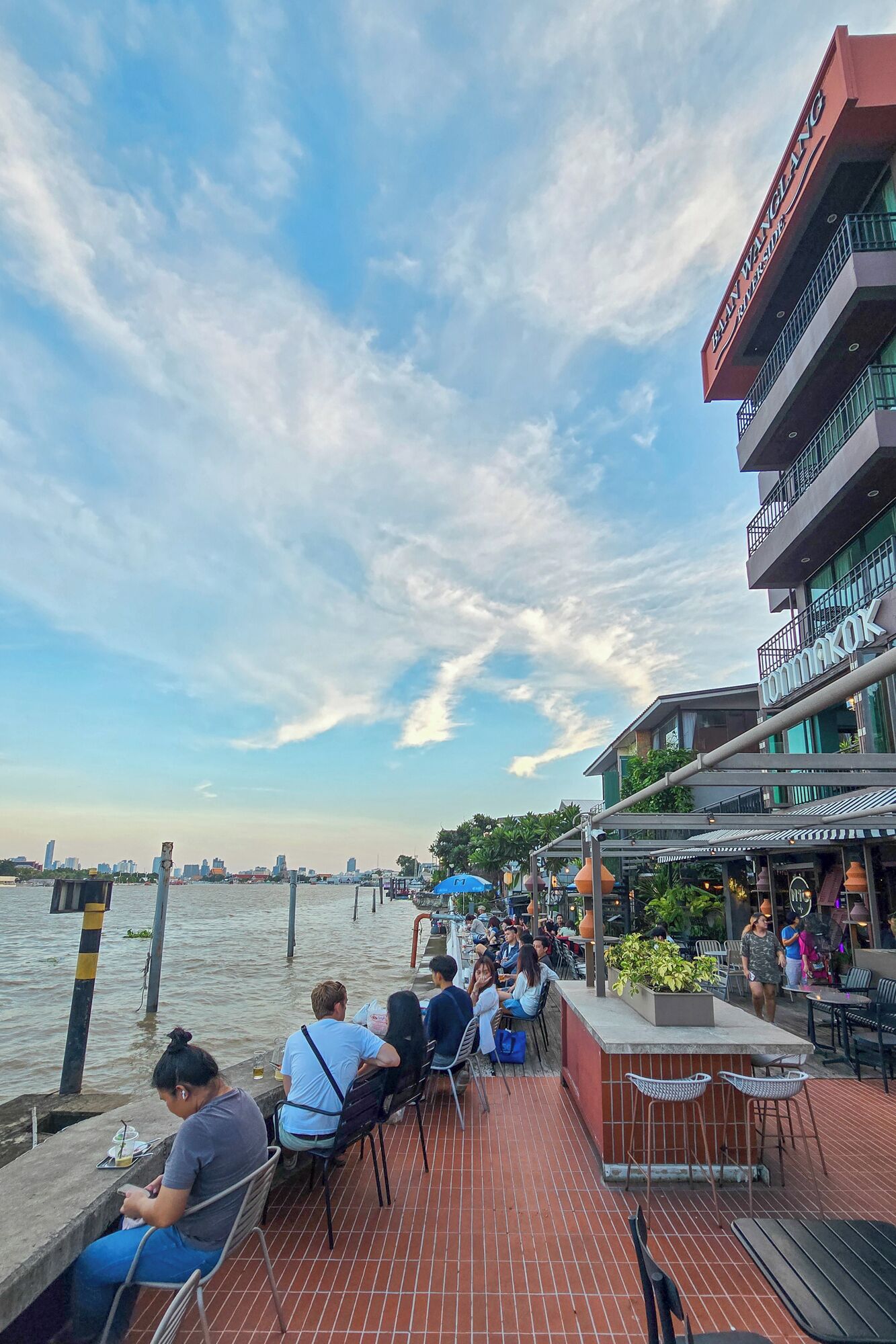 A waterfront restaurant with outdoor seating overlooking the water.