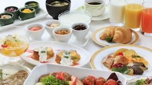 A variety of breakfast dishes including croissants, scrambled eggs, and fruit salad. - Atsugi Urban Hotel (Atsugi)