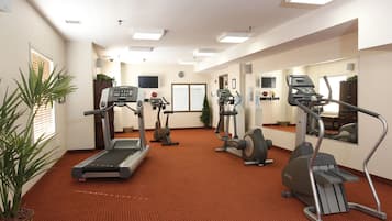 A fitness center with treadmills, elliptical machines, and a stationary bike.