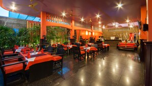 A restaurant with multiple tables and chairs, ceiling fans, and decorative lighting. - Golden Butterfly Villa (Siem Reap)