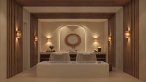 A modern bathroom with a large bathtub, two sinks, a mirror, and wall-mounted lighting. -  The Lince Ecorkhotel Évora (Évora)