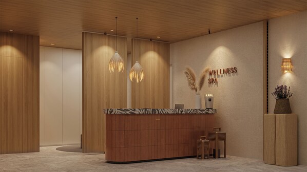 Un área de recepción con un mostrador de madera, luces colgantes y un cartel en la pared que dice 