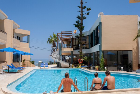 Outdoor pool, open 9:00 AM to 9:30 PM, pool umbrellas, pool loungers