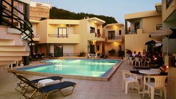 Outdoor pool, open 9:00 AM to 9:30 PM, pool umbrellas, pool loungers