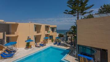 Outdoor pool, open 9:00 AM to 9:30 PM, pool umbrellas, pool loungers