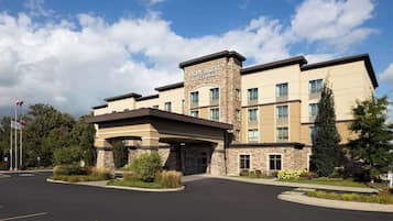 Welcome to Homewood Suites, featuring a covered entrance and landscaped garden.