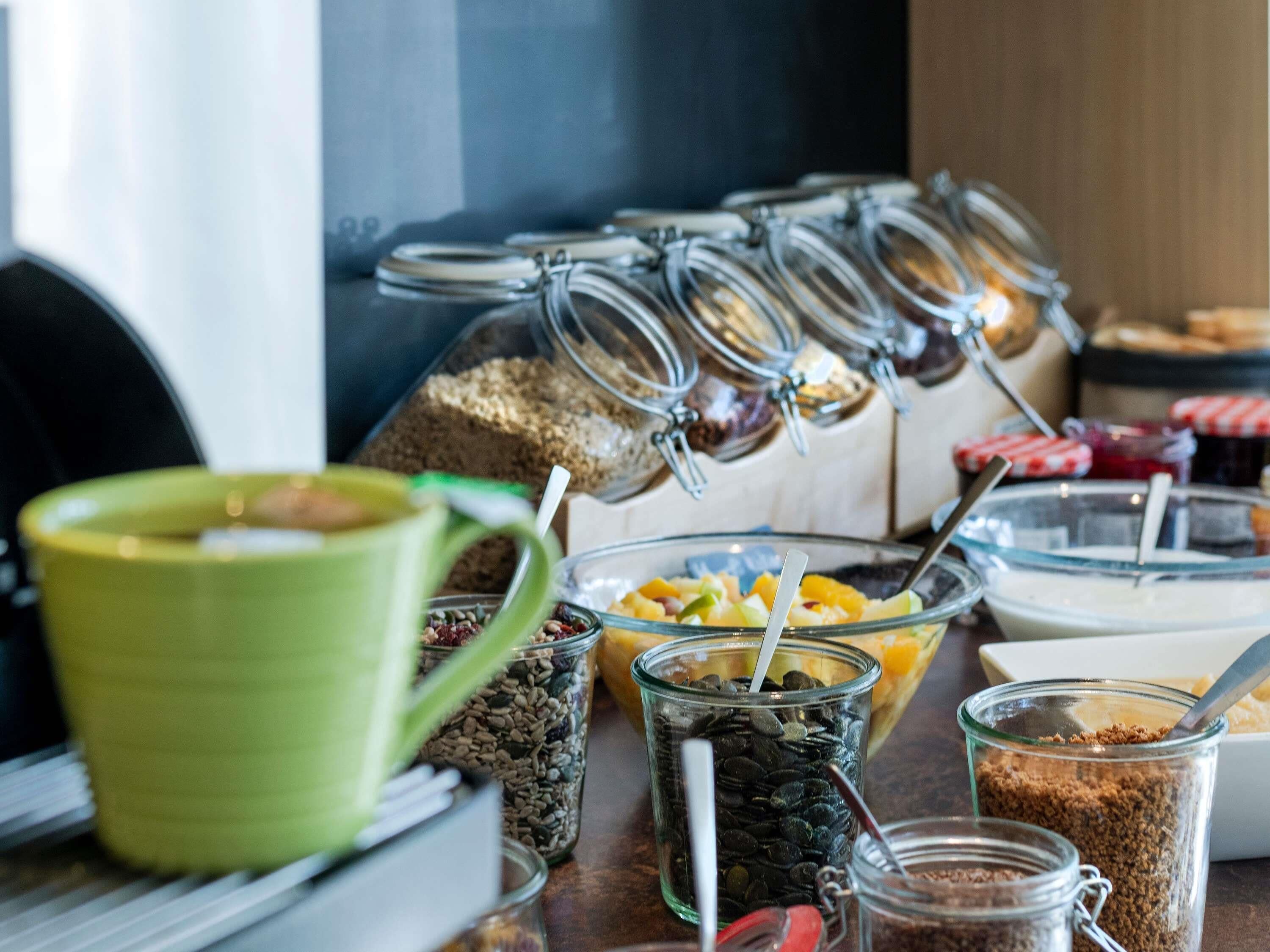 A breakfast buffet with various food items and containers.