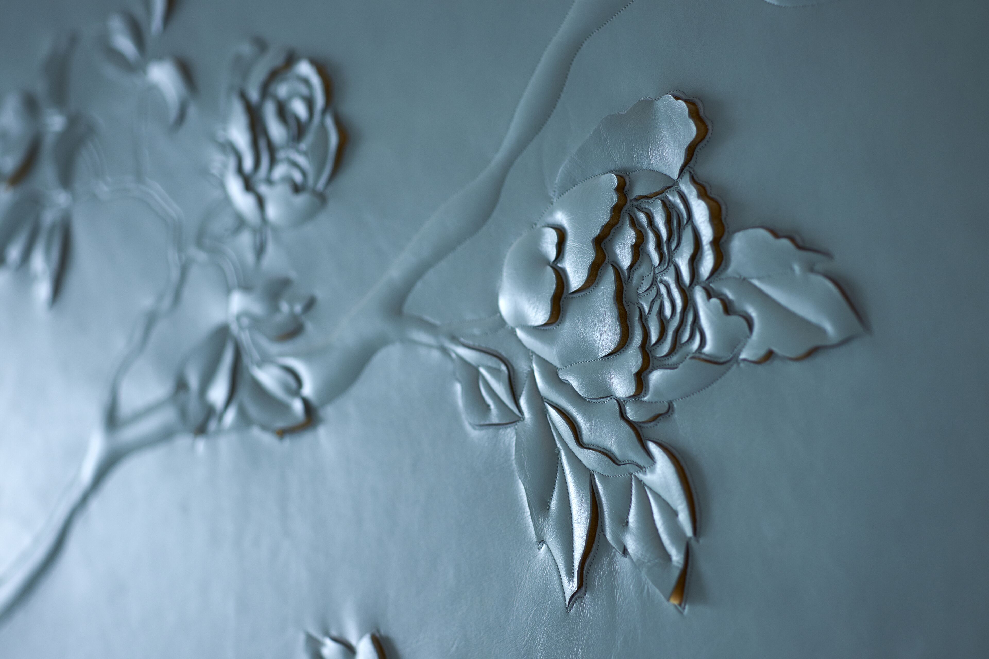 A close-up of a textured wall with floral patterns.