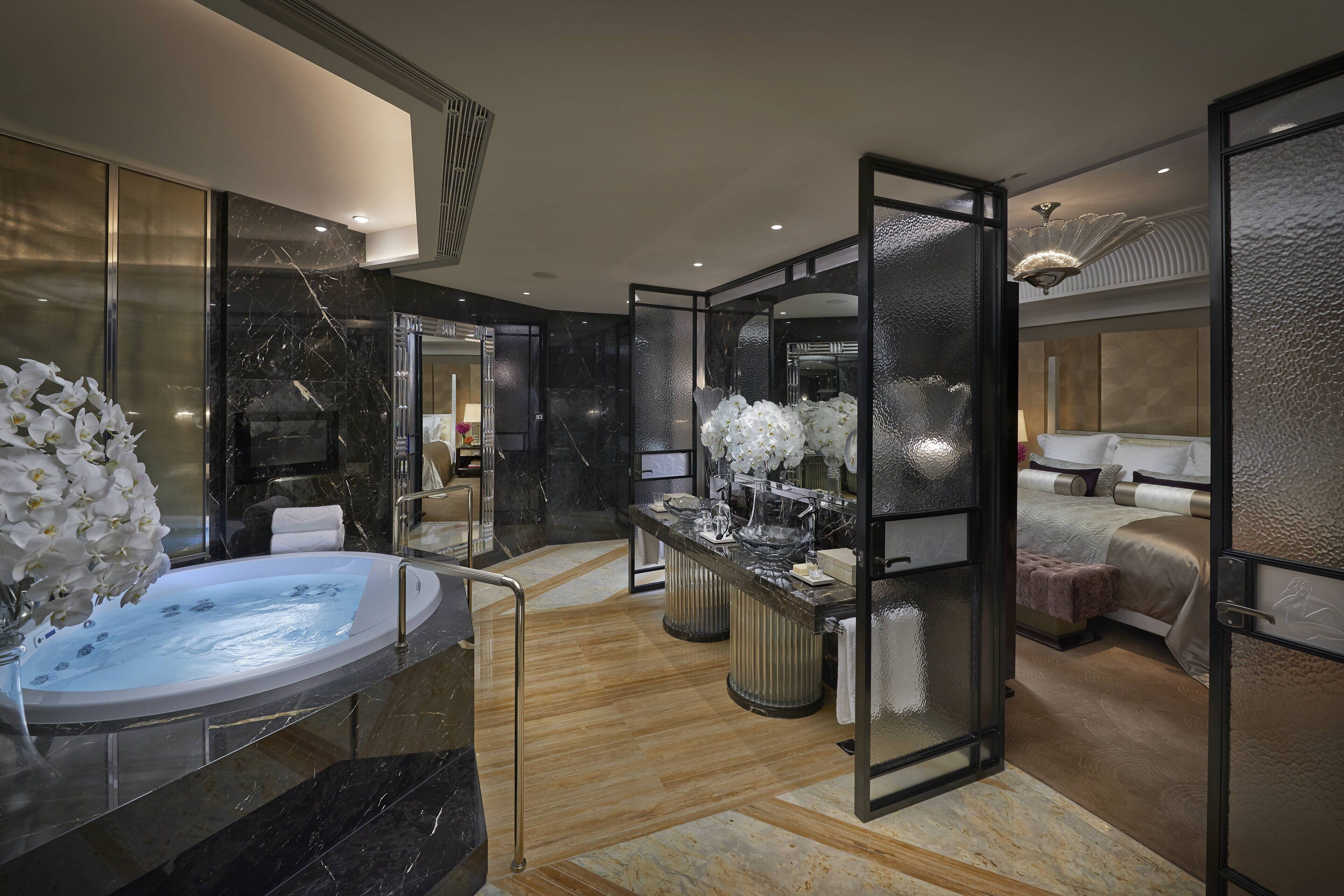 A modern bathroom with a freestanding bathtub, a vanity with a mirror, and a shower area.