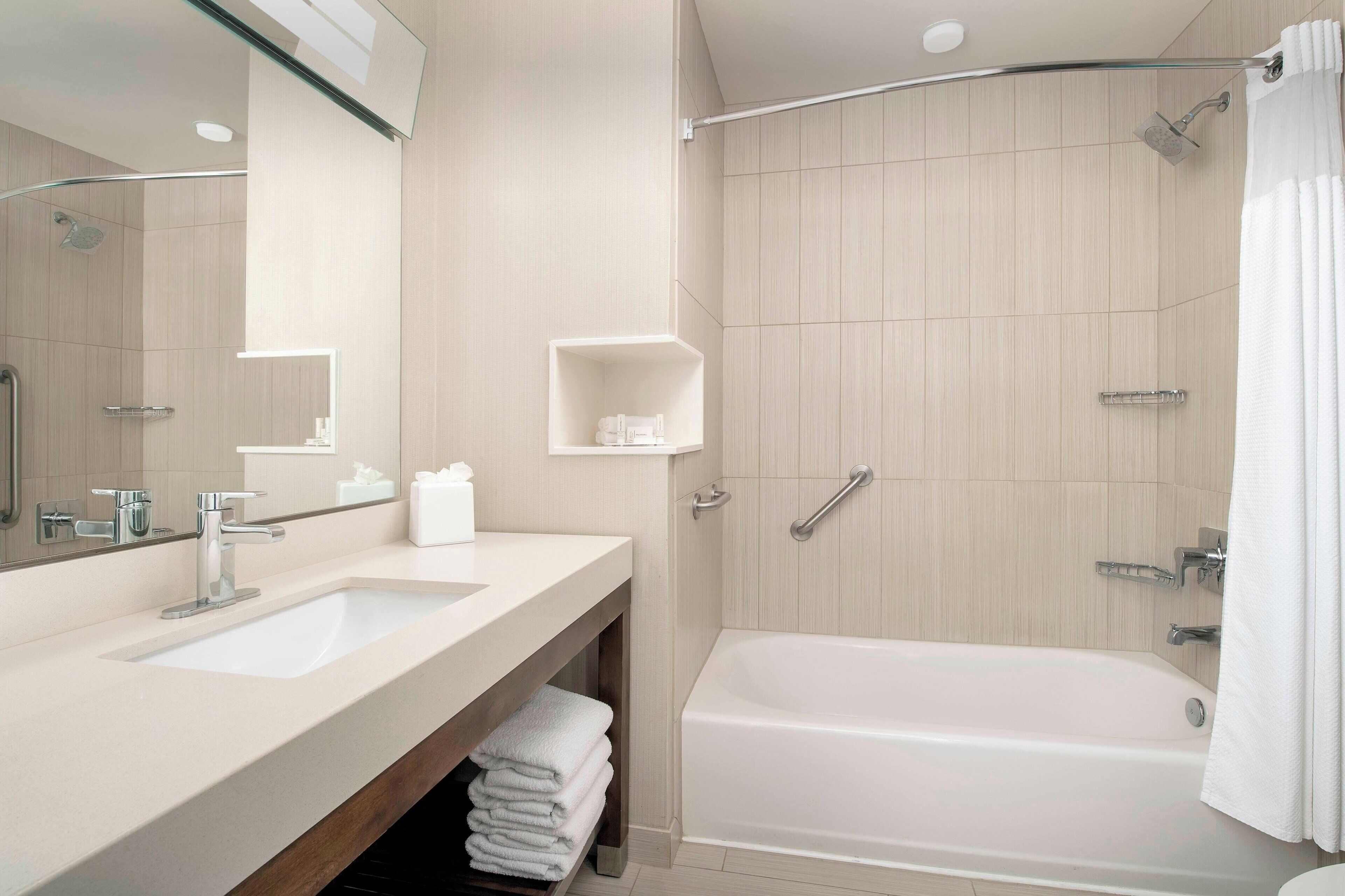 designer toiletries, hair dryer, towels