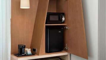 A compact kitchenette with a microwave, a mini-fridge, and a coffee maker.