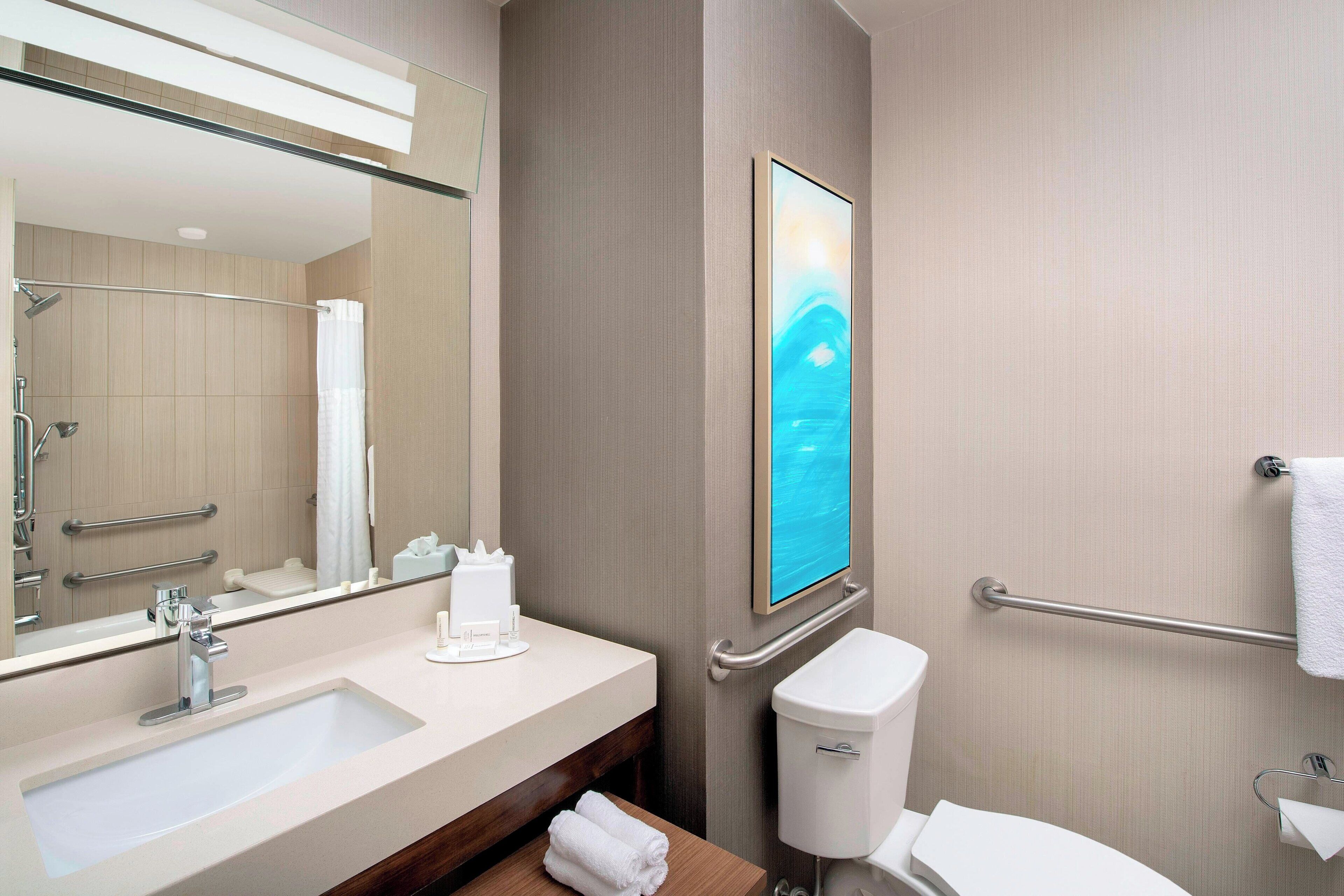 designer toiletries, hair dryer, towels