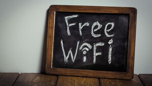 A blackboard with 'Free WiFi' written on it, framed in wood, placed on a wooden surface. - Relax Inn Bloomsburg (Bloomsburg)