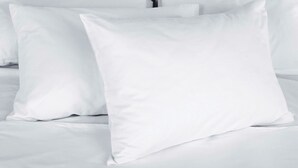 A bed with white bedding and pillows. - Relax Inn Bloomsburg (Bloomsburg)