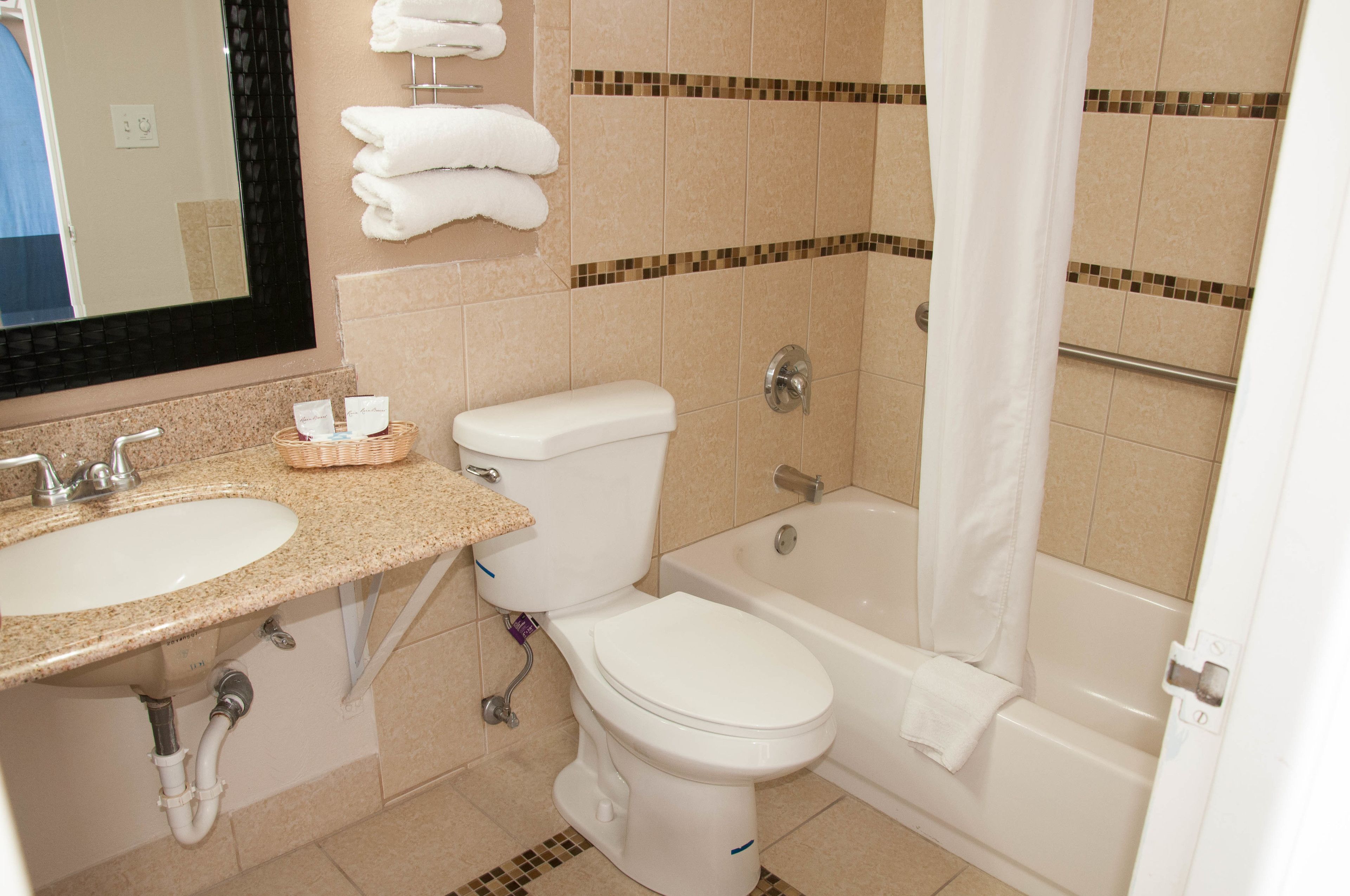 A bathroom with a sink, toilet, and bathtub.
