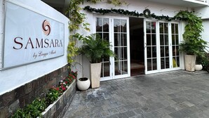 A building with a sign reading "Samsara by Lingga Aluti" and a balcony with white railings. - Samsara Inn (Kuta)