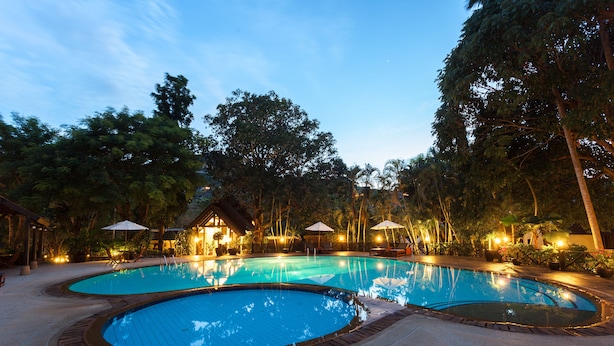 A pool area with two circular pools, surrounded by trees and outdoor seating. - Kamala Beach Estate (Kamala)
