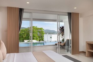 Ett hotellrum med en stor säng, utsikt över en utomhuspool och en balkong med en stol.