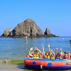 Guests can enjoy leisurely water activities on this colorful raft, marked 'WON', amidst a scenic rocky outcrop.