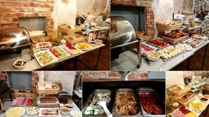 A buffet with various food items and a brick wall in the background. - Krakow For You Budget (Kraków)