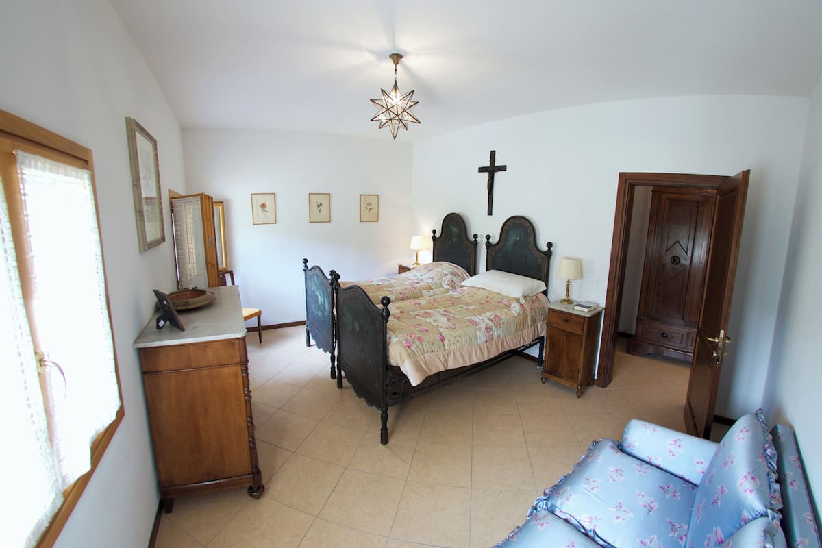 A bedroom with a bed, bedside table, and a wardrobe.