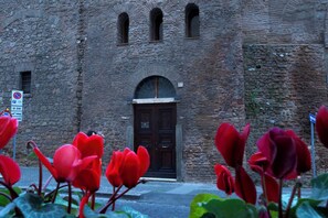 A stone building with a dark wooden door and arched windows. - St. Peter' Six Rooms & Suites (Rome)