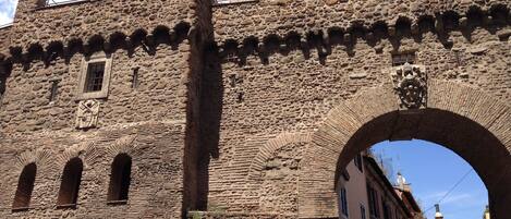 A stone castle with arched gateways and battlements.