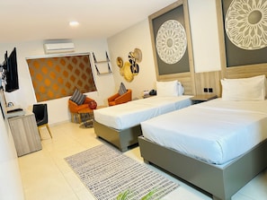 A hotel room with two beds, a desk, a chair, a TV, and decorative wall art. - Fairway Hotel & Spa (Kampala)