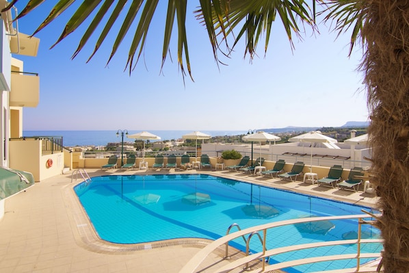 Seasonal outdoor pool, pool umbrellas, pool loungers