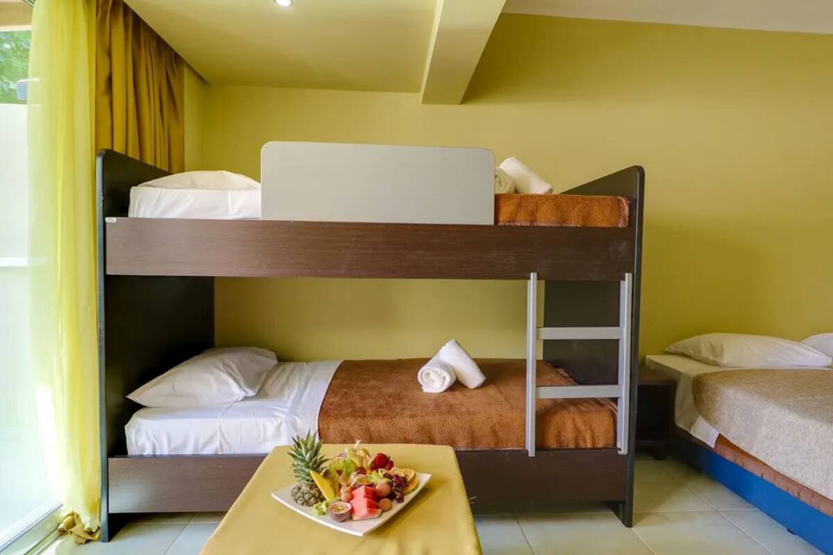 A bunk bed room with a breakfast tray on the lower bunk.