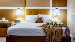 A well-lit bedroom with a large bed, two bedside tables, and a headboard. - Hotel Lino Mare (Malevizi)