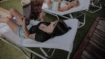 Relax in a serene outdoor space with two lounge chairs and comfortable cushions.