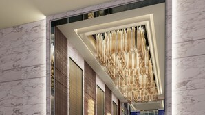 A modern hallway with marble walls and a ceiling light fixture. - Shanghai Marriott Hotel Parkview (Shanghai)