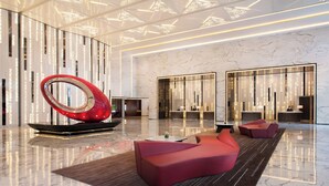 A modern lobby with a reflective red sculpture, plush seating, and a marble floor. - Shanghai Marriott Hotel Parkview (Shanghai)