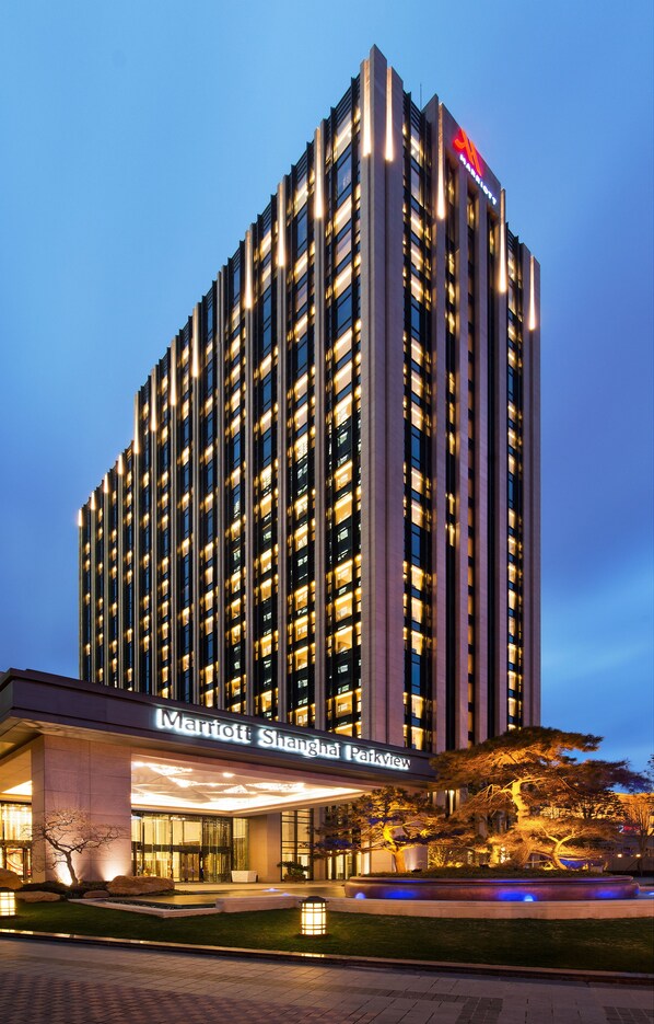 A tall, modern hotel with a prominent sign for Marriott Shanghai Parkview.