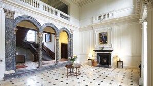A grand hall with a marble floor, a staircase, and a fireplace. - Chicheley Hall (Newport Pagnell)