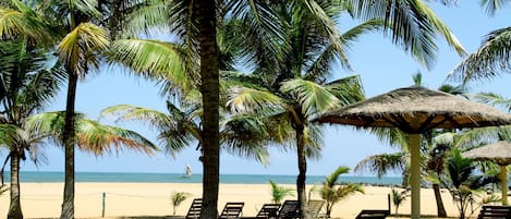 On the beach, sun loungers, beach umbrellas, water skiing