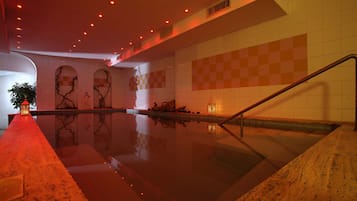 Relax by the serene pool, surrounded by a checkered pattern and lush greenery.
