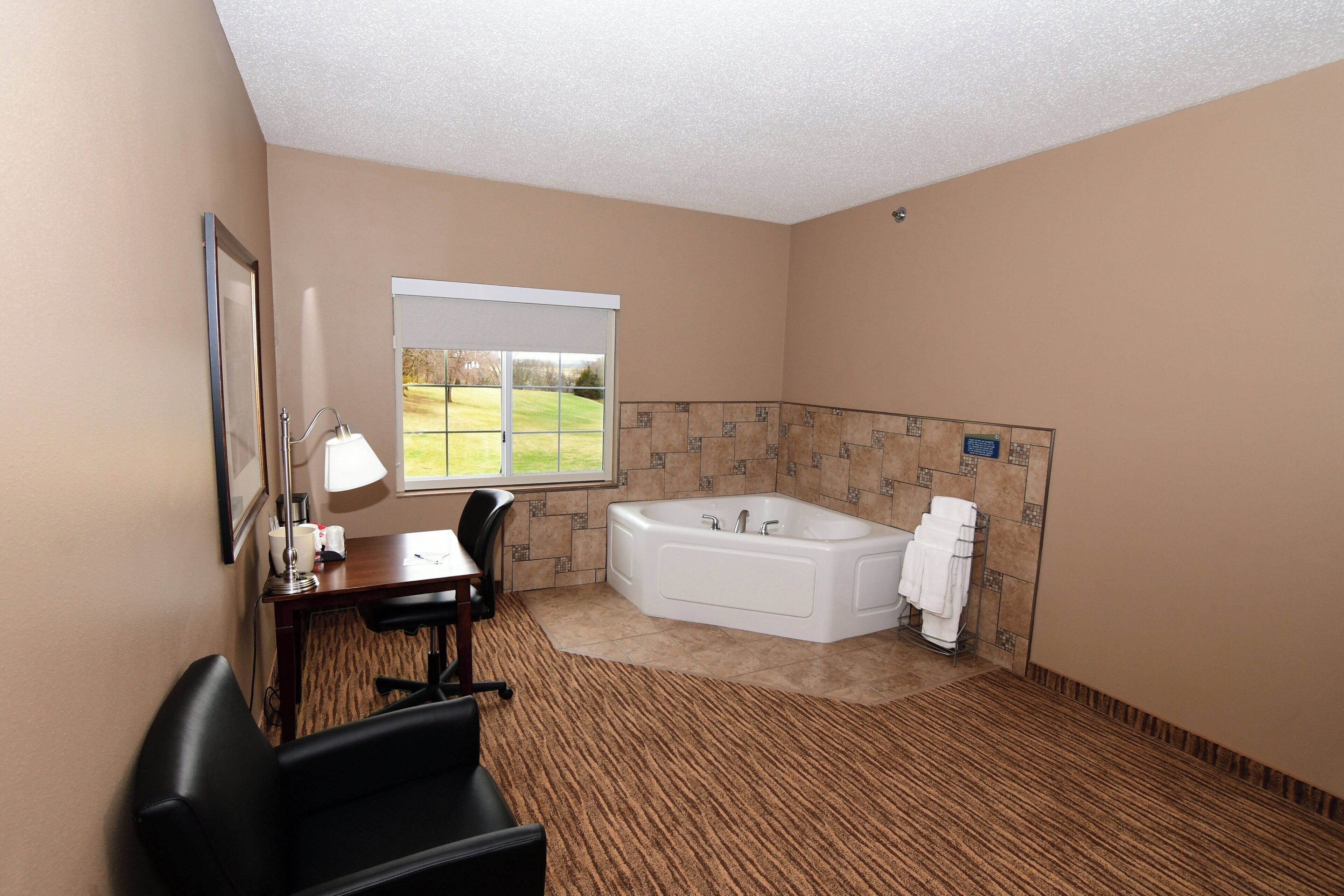 suite, 1 king bed with jacuzzi, non smoking | in-room safe, desk, laptop workspace, iron/ironing board
