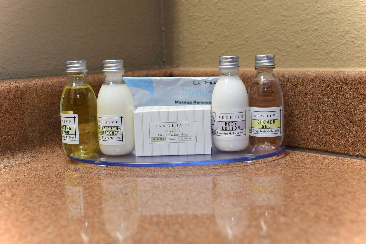 A countertop with various personal care products including a facial cleansing foam, a body lotion, a relaxing conditioner, a body lotion, and a shower gel.