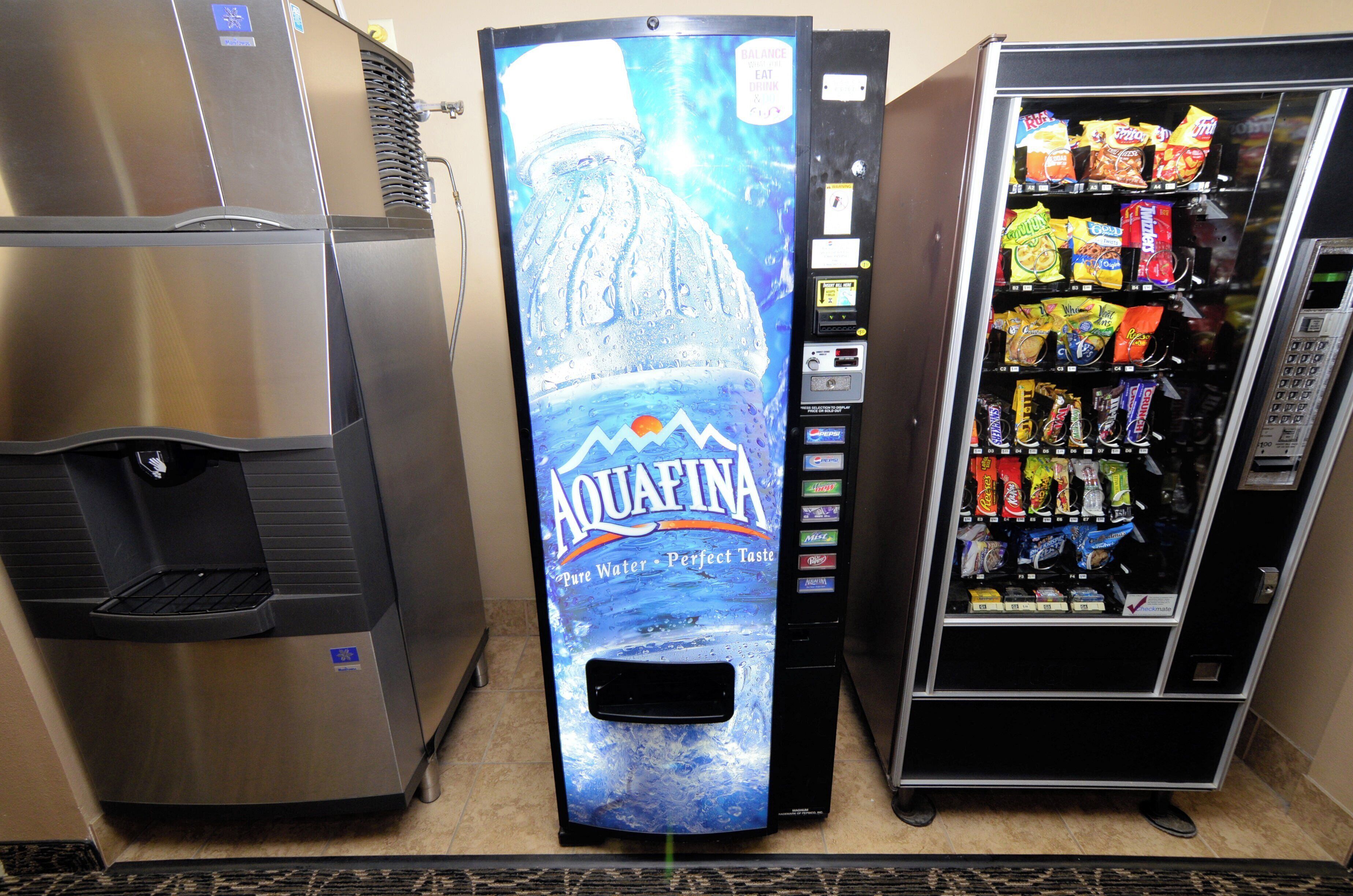 A vending machine with a water dispenser and a selection of snacks.