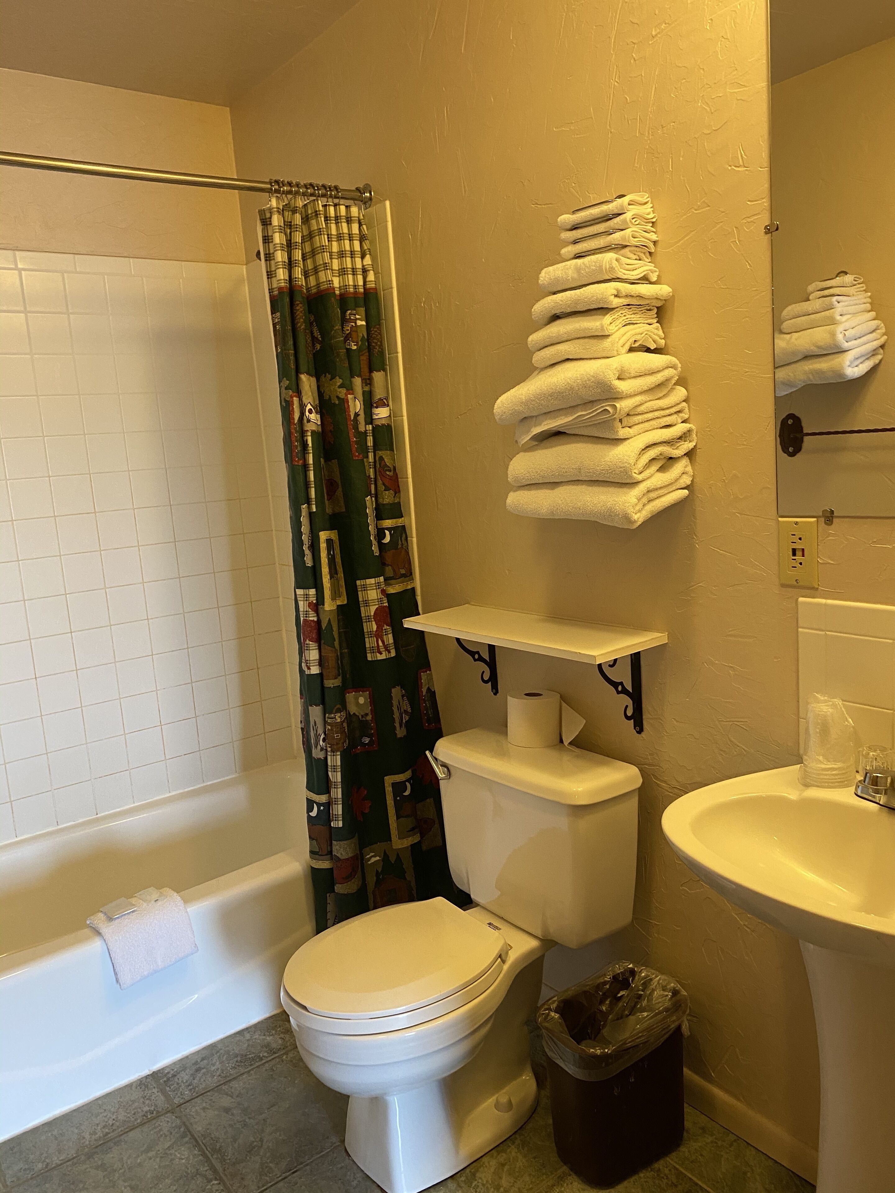 A bathroom with a toilet, sink, and bathtub.
