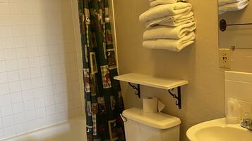 A bathroom with a toilet, sink, and bathtub.