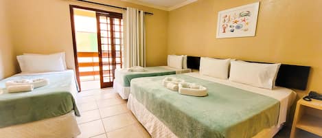 A hotel room with two beds, a large window with curtains, a wall-mounted artwork, and a small wooden nightstand.