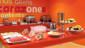 A buffet setup with various food items and beverages, including fruits, salads, and hot beverages. - One Silao (Silao)